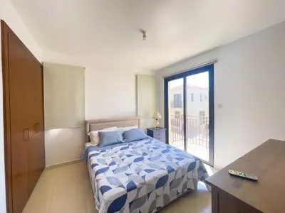 a bedroom with a bed and a large window at Villa Chrysa in Protaras