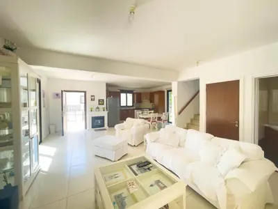 a living room with a white couch and a table at Villa Chrysa in Protaras
