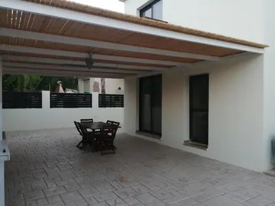a patio with a table and chairs on it at Villa Chrysa in Protaras