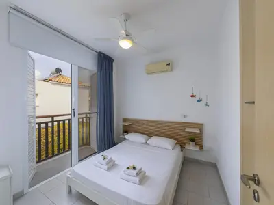 a bedroom with a bed and a balcony at Passion Villa in Protaras