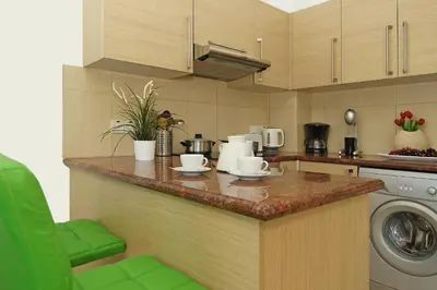 a kitchen with a counter top with a dishwasher at Calypso - Coralli Beachfront Apartment in Protaras