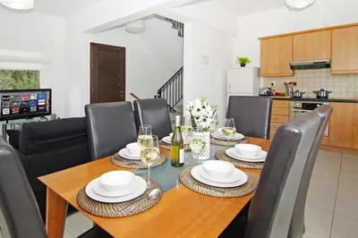 a dining room with a wooden table and chairs at Villa Anette in Protaras
