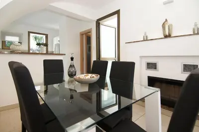 a dining room with a glass table and chairs at Villa Ingrid in Ayia Napa