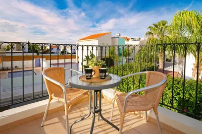 a patio with a table and chairs on a balcony at Villa Summer in Protaras