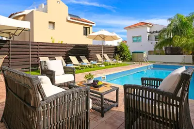 a patio with chairs and a swimming pool at Villa Summer in Protaras