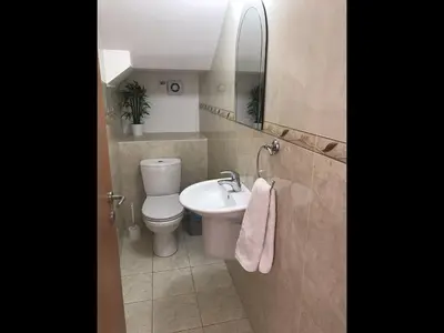 a bathroom with a toilet and a sink and a mirror at Villa Nissi Beach 28 in Ayia Napa