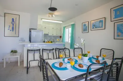a dining room with a table with plates of food on it at Protaras Holiday Suite Annie in Protaras