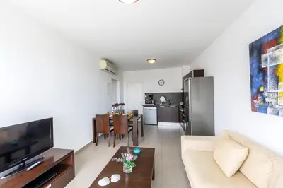 a living room with a couch and a table at Coralli Spa By Fig tree Bay in Protaras
