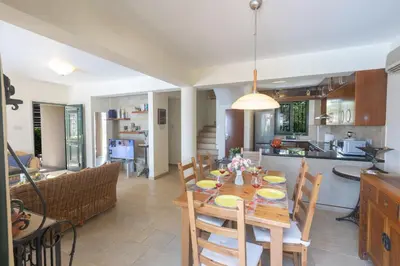 a dining room and kitchen with a table and chairs at Spetses Villa 5 in Protaras