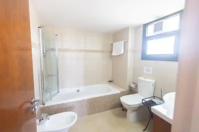 a bathroom with a tub and a toilet and a sink at Spetses Villa 5 in Protaras