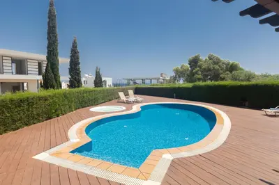 a swimming pool on a patio with a house at Spetses Villa 5 in Protaras