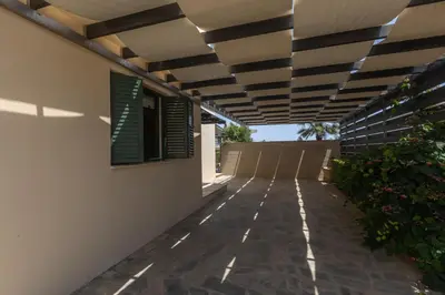 a walkway outside of a house with awning at Spetses Villa 5 in Protaras