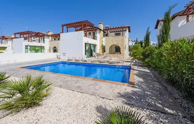 a swimming pool in front of a house at Kymma Villa #16 in Ayia Napa