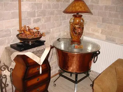 a lamp on top of a glass table next to a dresser at The Love Holiday House in Tris Elies