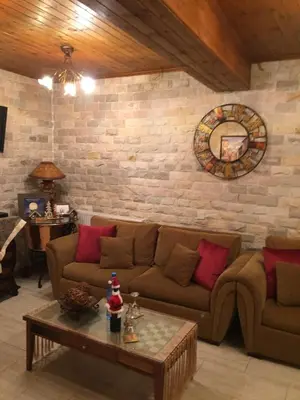 a living room with a couch and a table at The Love Holiday House in Tris Elies