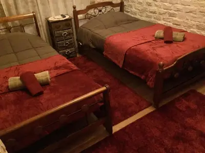 two beds with red covers in a room at The Love Holiday House in Tris Elies