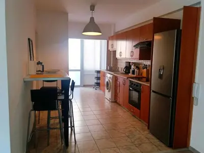 a kitchen with a refrigerator and a table with chairs at Markora Central Apartment in Nicosia