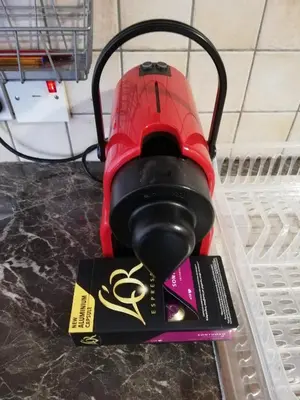 a red object is sitting on a shelf with a book at Markora Central Apartment in Nicosia