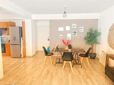 a kitchen and dining room with a table and chairs at Markora Central Apartment in Nicosia