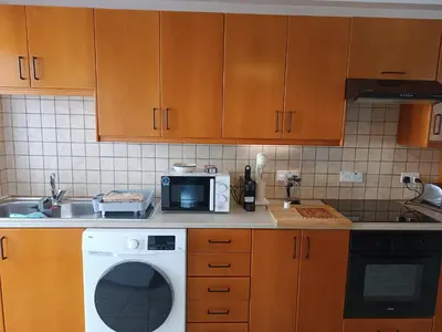 a kitchen with a washing machine and a sink at Markora Central Apartment in Nicosia
