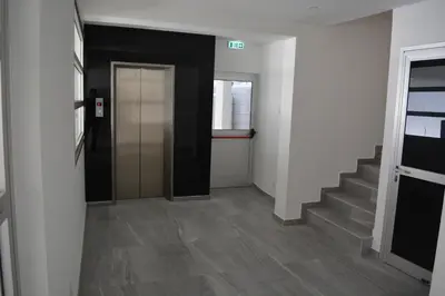 a hallway with stairs and a door in a building at P L PANAGIOTIS Apartment in Larnaka