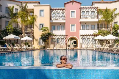 a man in the swimming pool at a hotel at Louis Althea Beach in Protaras