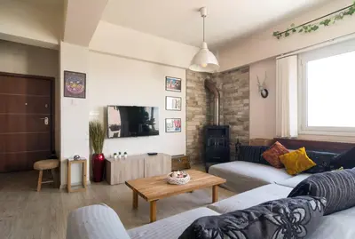 a living room with a couch and a table at Vas' Penthouse in Nicosia