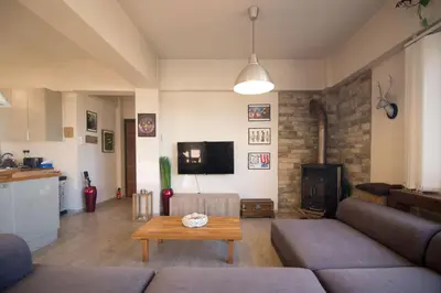 a living room with a couch and a table at Vas' Penthouse in Nicosia
