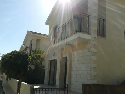 a building with the sun shining on the side of it at Marias Villa in Protaras