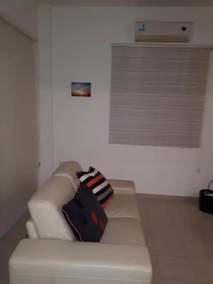 a white couch with two pillows on it in a room at Marias Villa in Protaras
