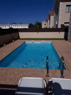 a swimming pool on the side of a building at Marias Villa in Protaras