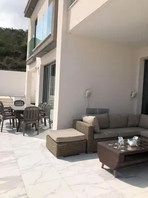 a patio with a couch and a table and chairs at Villa Spathele in Paralimni