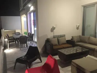 a living room with a couch and a table and chairs at Villa Spathele in Paralimni