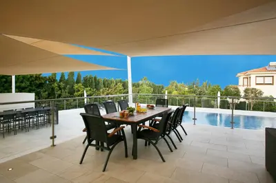 a patio with a table and chairs and a piano at Villa Leonidas in Protaras