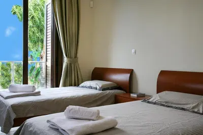 a hotel room with two beds and a window at Villa Leonidas in Protaras