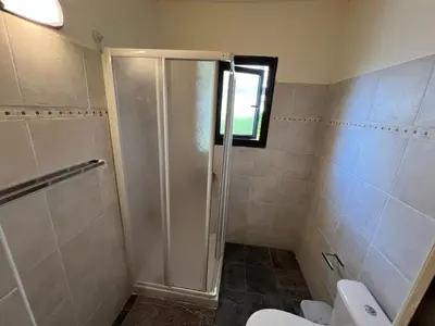 a bathroom with a shower and a toilet at George Apartments in Ayia Napa