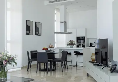 a kitchen and dining room with a table and chairs at Nicosia Central Park Residences in Nicosia