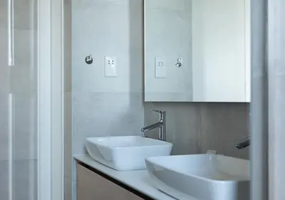 a bathroom with a white sink and a mirror at Nicosia Central Park Residences in Nicosia