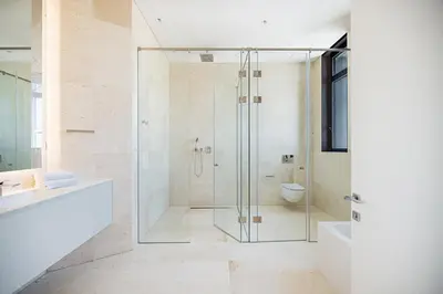 a bathroom with a shower with a sink and a toilet at Nicosia Central Park Residences in Nicosia