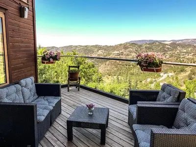 a deck with couches and a table with a view at Vasiliou House Krimenos in Khandria