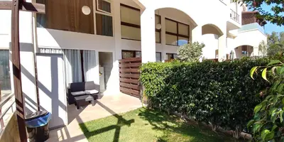 a view from the outside of a house with a green hedge at Galatex Beach Apartment in Limassol