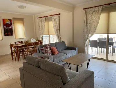 a living room with a couch and a table at Villas Ithaca Protaras in Protaras