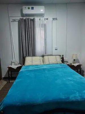 a blue bed in a room with a window at Christos House in Kakopetria