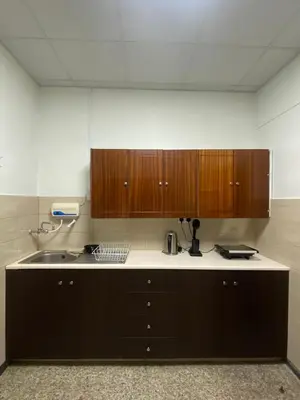 a kitchen with a sink and wooden cabinets at Christos House in Kakopetria