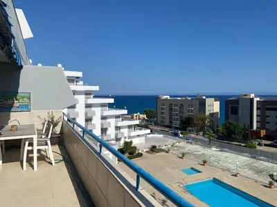 a balcony of a building with a swimming pool at Alania Sea View Apartment in Limassol