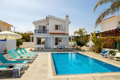 a villa with a swimming pool and a house at Fig Tree Bay Villa 3 in Protaras
