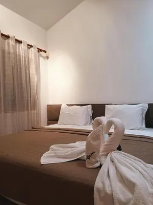 a hotel room with two beds with towels on the bed at Oasi Rejuve Villa in Meneou