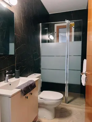 a bathroom with a toilet and a sink and a shower at Oasi Rejuve Villa in Meneou