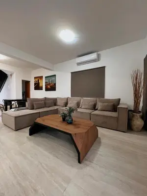 a living room with a couch and a coffee table at Oasi Rejuve Villa in Meneou