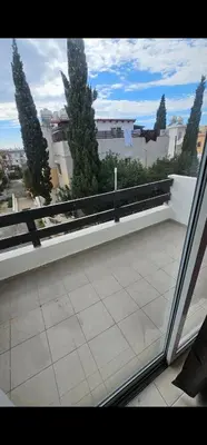 a balcony with a bench and trees on a building at Luxury Apartment Ayia Napa Center in Ayia Napa